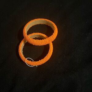Orange beaded bangles, set of two.